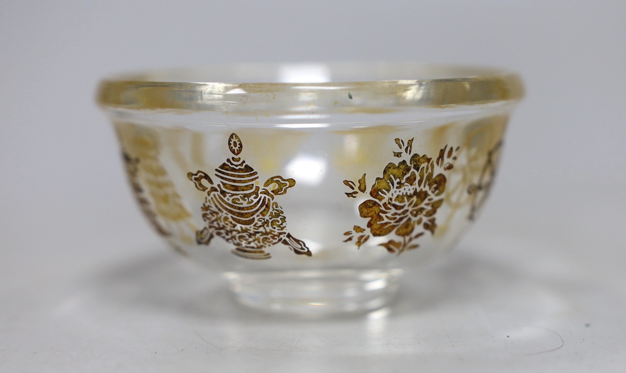 A Tibetan glass dish with gilt interior decoration. 9cm diameter